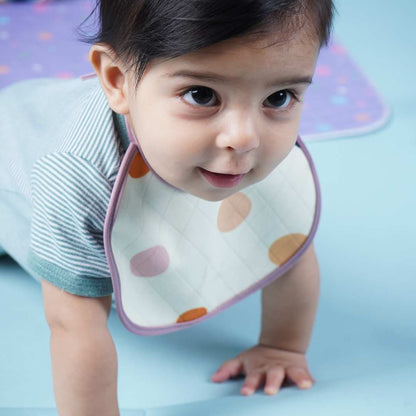 Baby-crawling-and-wearing-polka-printed-bib