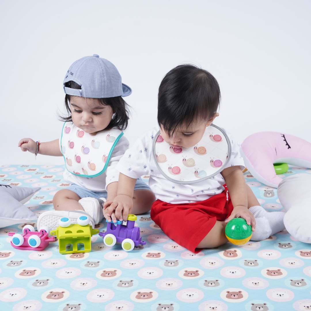 Two-Babies-Playing-on-crib-sheet