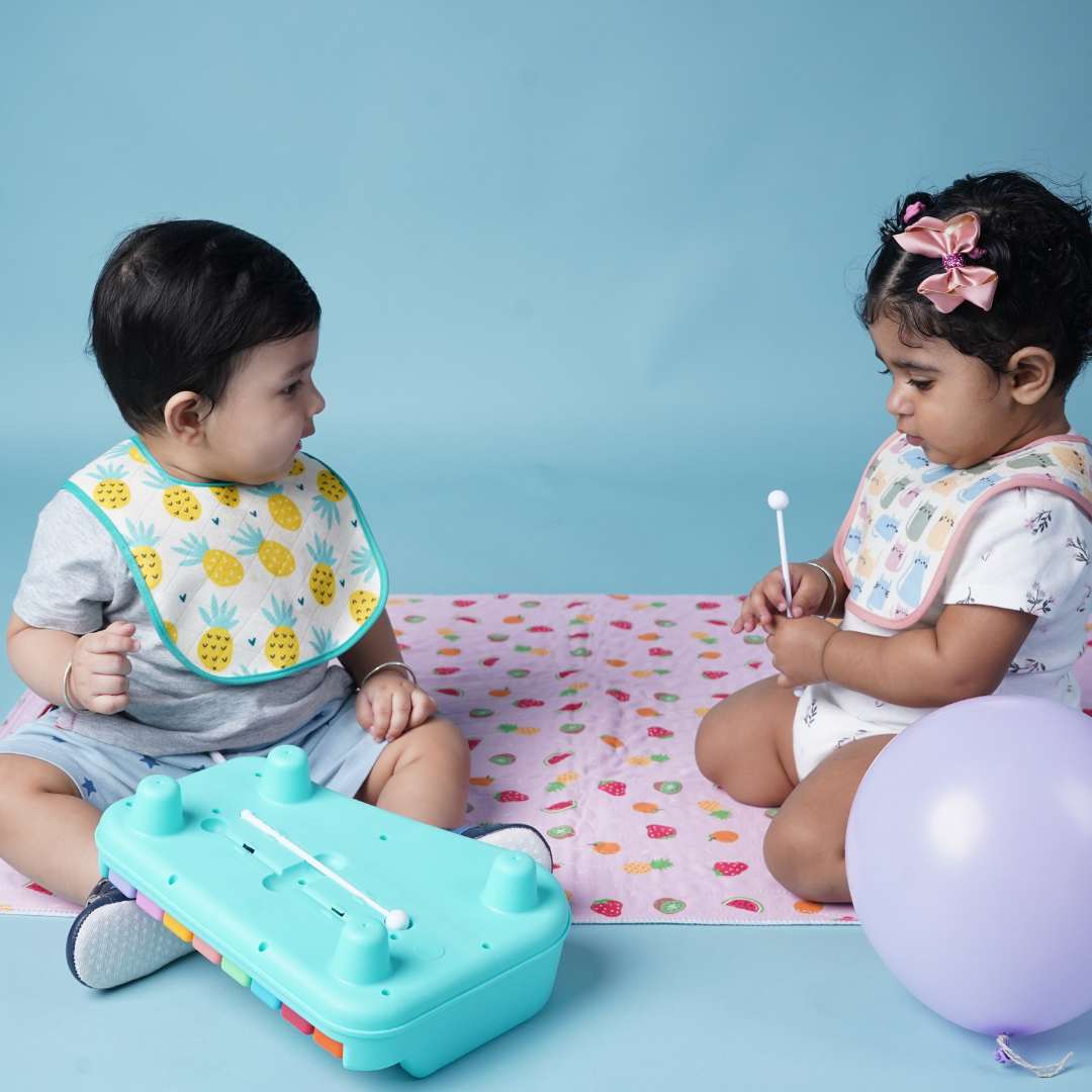 two-babies-playing-oncrib-sheet