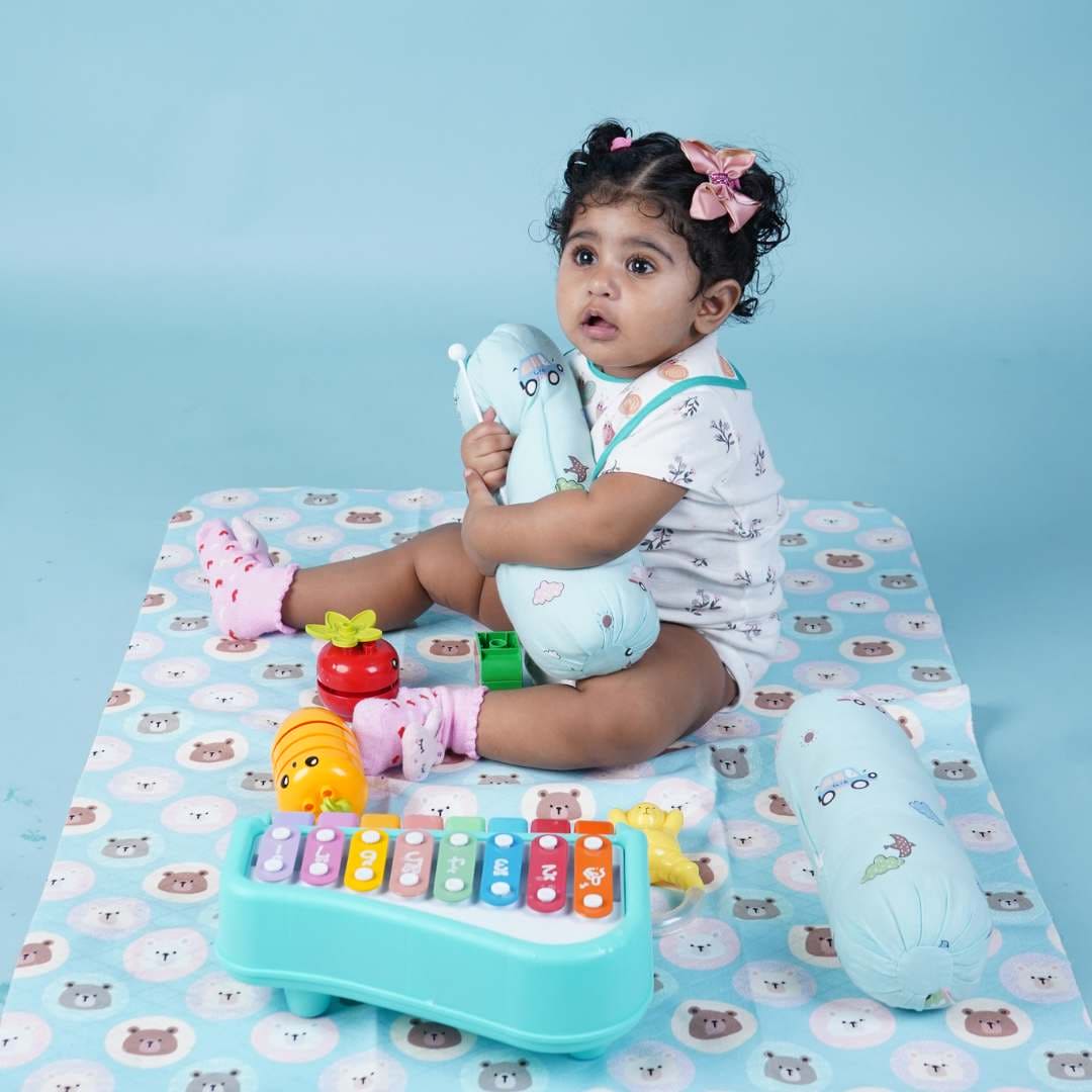 Baby-sitting-and-playing-on-crib-sheet