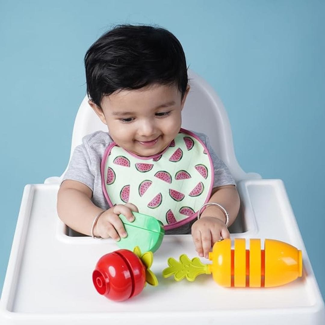 Baby-wearing-printed-bib-while-sitting-on-chair