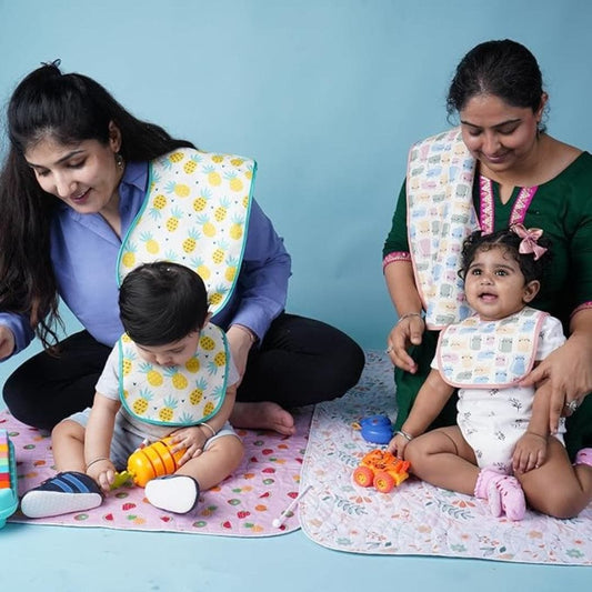 Two-mothers-playing-with-their-babies-on-playmat
