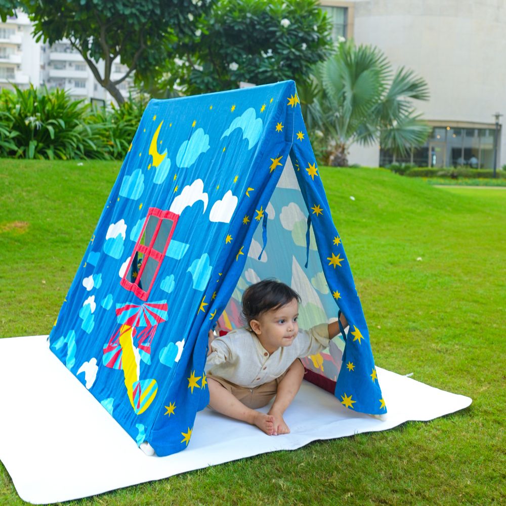 Baby playing with midnight play tent
